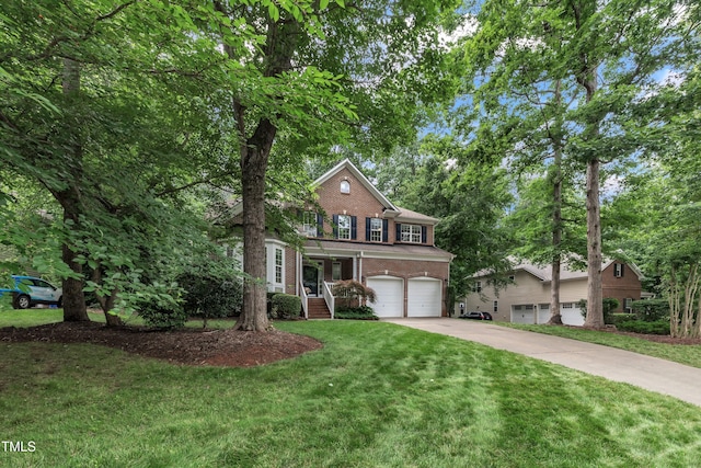 522 N Scotswood Blvd, Hillsborough, NC 27278 - view of front of house featuring brick siding, driveway, a garage, and a front lawn