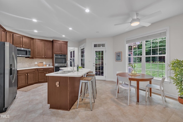 522 N Scotswood Blvd, Hillsborough, NC 27278 - kitchen with stainless steel appliances, a sink, tasteful backsplash, light countertops, and baseboards