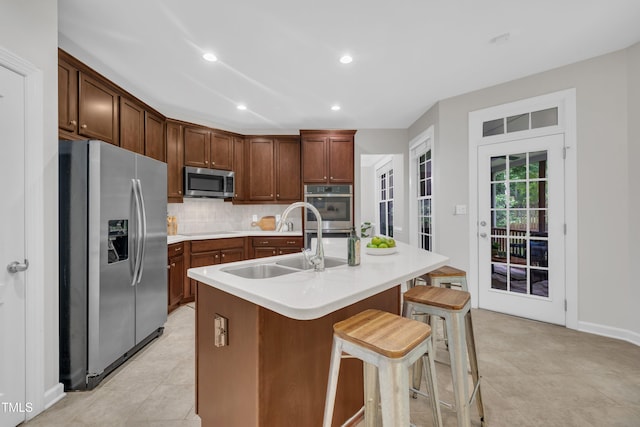 522 N Scotswood Blvd, Hillsborough, NC 27278 - kitchen with appliances with stainless steel finishes, a sink, backsplash, a breakfast bar area, and light countertops