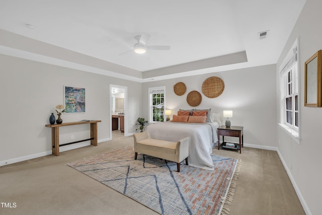 522 N Scotswood Blvd, Hillsborough, NC 27278 - bedroom with light colored carpet, a raised ceiling, baseboards, ensuite bathroom, and ceiling fan