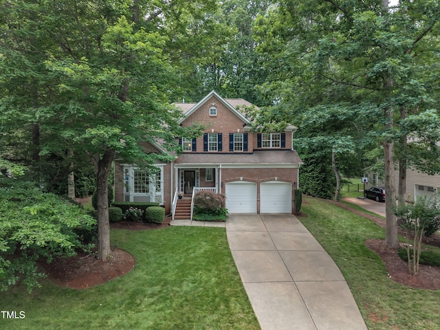 522 N Scotswood Blvd, Hillsborough, NC 27278 - view of front of house featuring brick siding, a garage, driveway, and a front lawn