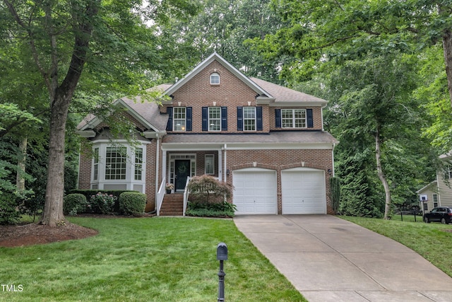 522 N Scotswood Blvd, Hillsborough, NC 27278 - view of front of property with an attached garage, a front yard, driveway, and brick siding