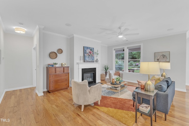 151 Bridge St, Hillsborough, NC 27278 - living area featuring light wood finished floors, a glass covered fireplace, ornamental molding, ceiling fan, and baseboards