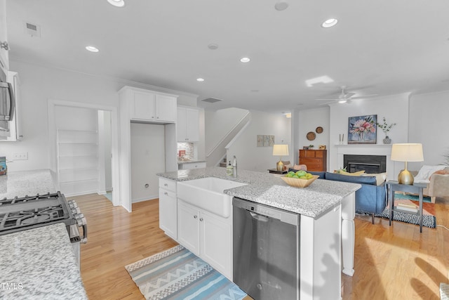 151 Bridge St, Hillsborough, NC 27278 - kitchen featuring stainless steel appliances, ceiling fan, white cabinets, light wood finished floors, and a sink