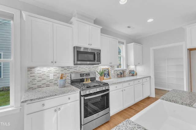 151 Bridge St, Hillsborough, NC 27278 - kitchen featuring stainless steel appliances, white cabinetry, a sink, backsplash, and recessed lighting
