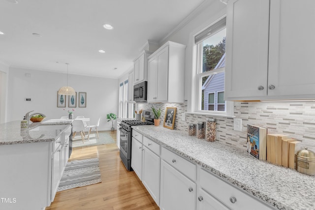 151 Bridge St, Hillsborough, NC 27278 - kitchen with appliances with stainless steel finishes, healthy amount of natural light, a sink, white cabinetry, and crown molding