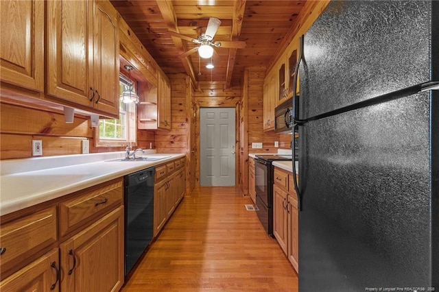 113 Atwood Ter, Stedman, NC 28391 - kitchen with black appliances, wood ceiling, wooden walls, light wood-style flooring, and brown cabinets