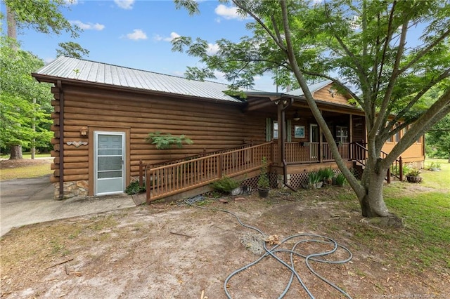 113 Atwood Ter, Stedman, NC 28391 - view of front of house with log exterior, covered porch, and metal roof