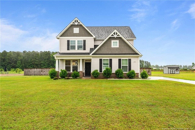 6752 Running Fox Rd, Hope Mills, NC 28348 - craftsman house featuring a front yard, a storage shed, a porch, and a shingled roof