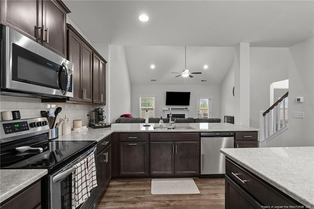 6752 Running Fox Rd, Hope Mills, NC 28348 - kitchen with appliances with stainless steel finishes, a ceiling fan, open floor plan, dark brown cabinets, and dark wood finished floors