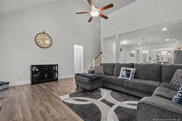6752 Running Fox Rd, Hope Mills, NC 28348 - living area with wood finished floors, stairs, ceiling fan, high vaulted ceiling, and baseboards