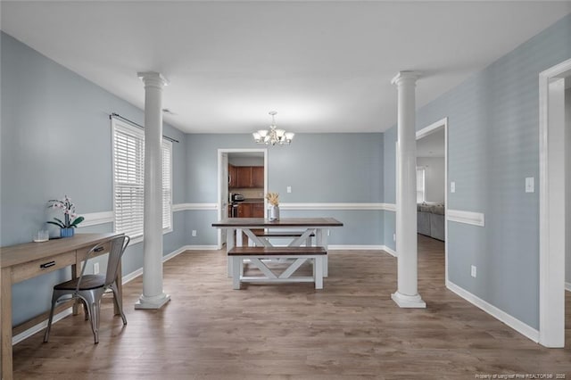 625 Fairfield Cir, Raeford, NC 28376 - dining area featuring decorative columns, wood finished floors, baseboards, and a chandelier