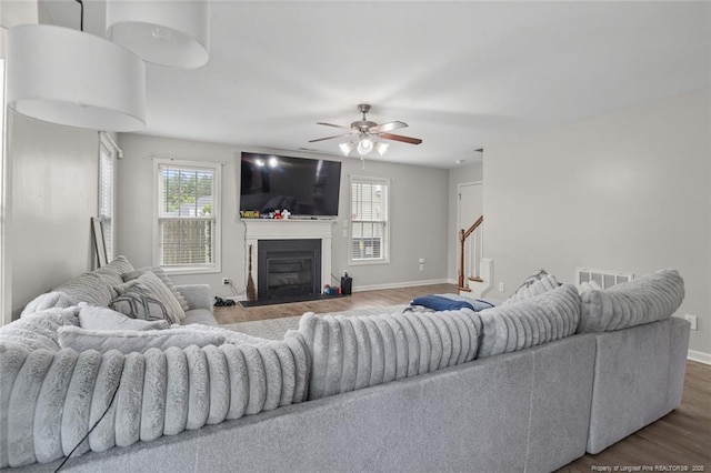 625 Fairfield Cir, Raeford, NC 28376 - living room with wood finished floors, ceiling fan, stairway, and baseboards