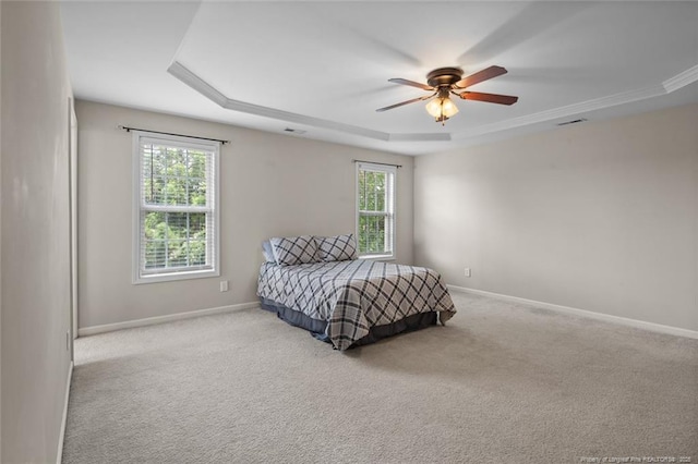 625 Fairfield Cir, Raeford, NC 28376 - carpeted bedroom with a raised ceiling, multiple windows, baseboards, and a ceiling fan