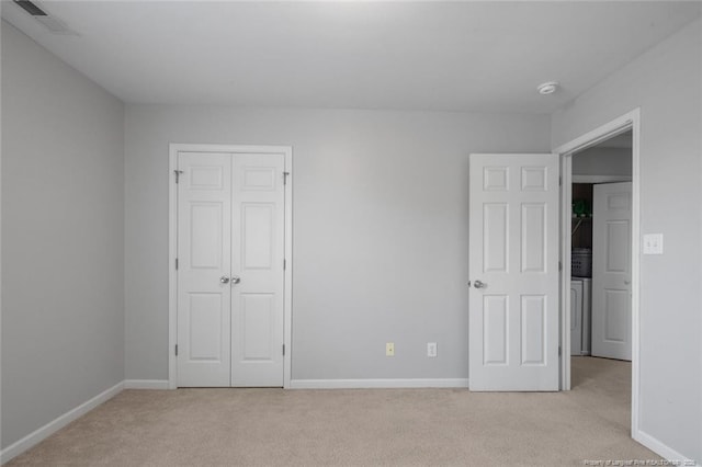 625 Fairfield Cir, Raeford, NC 28376 - unfurnished bedroom featuring light colored carpet, baseboards, a closet, and washer / clothes dryer