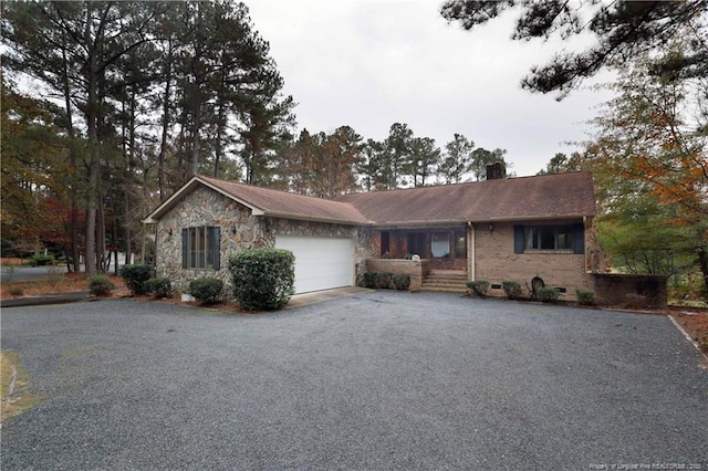 750 Mimosa Dr, Vass, NC 28394 - single story home with a chimney, an attached garage, asphalt driveway, and stone siding