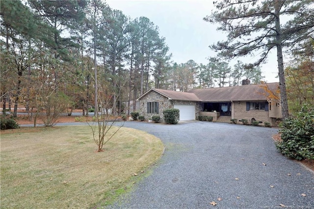 750 Mimosa Dr, Vass, NC 28394 - ranch-style home featuring curved driveway, a garage, stone siding, a chimney, and a front lawn