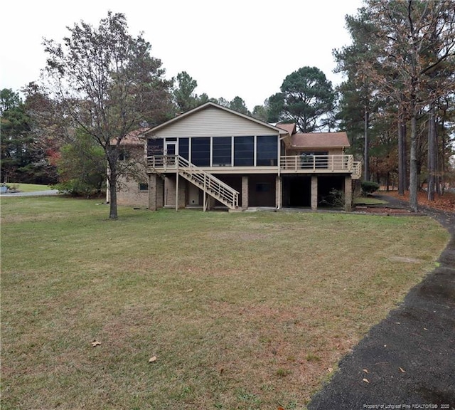 750 Mimosa Dr, Vass, NC 28394 - back of house featuring stairway, a sunroom, a deck, and a lawn