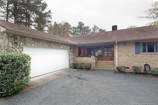 750 Mimosa Dr, Vass, NC 28394 - ranch-style home with a garage, a chimney, driveway, brick siding, and stone siding