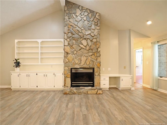 750 Mimosa Dr, Vass, NC 28394 - unfurnished living room featuring lofted ceiling, light wood-style flooring, a stone fireplace, baseboards, and an office area