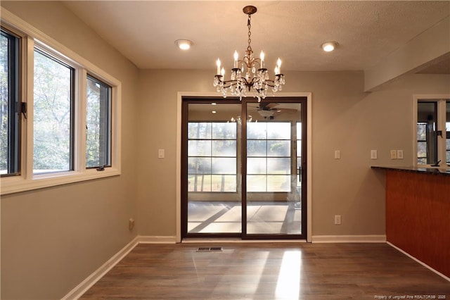 750 Mimosa Dr, Vass, NC 28394 - unfurnished dining area with dark wood finished floors, baseboards, ceiling fan, and a chandelier