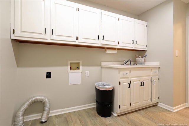 750 Mimosa Dr, Vass, NC 28394 - washroom featuring electric dryer hookup, cabinet space, light wood-style flooring, and baseboards