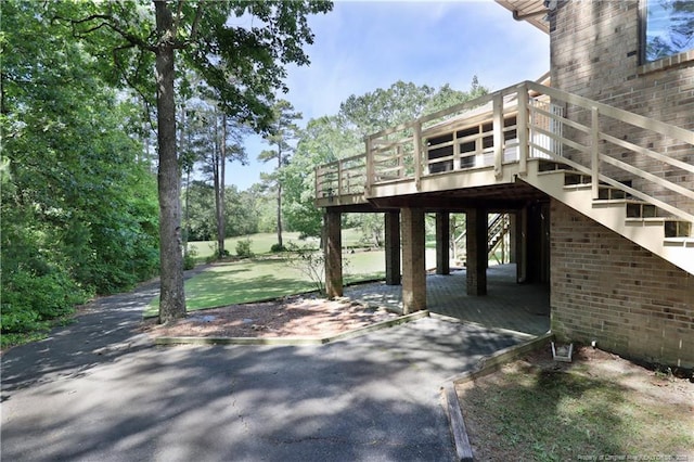 750 Mimosa Dr, Vass, NC 28394 - view of patio featuring a carport, a wooden deck, stairs, and driveway