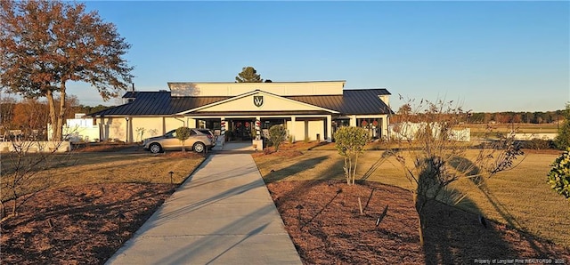 750 Mimosa Dr, Vass, NC 28394 - view of front facade featuring driveway, metal roof, an attached carport, and a standing seam roof