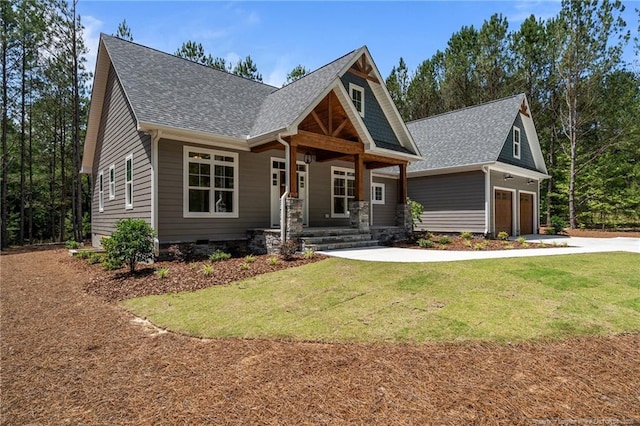 5400 Dowd Rd, West End, NC 27376 - craftsman-style house with roof with shingles, driveway, covered porch, a front yard, and a garage