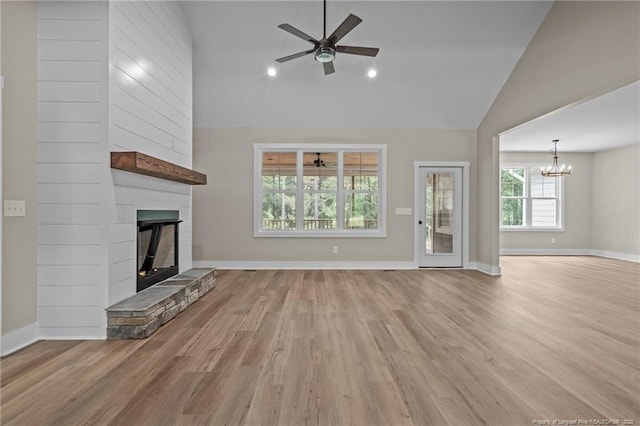 5400 Dowd Rd, West End, NC 27376 - unfurnished living room with lofted ceiling, ceiling fan, a large fireplace, a chandelier, and wood finished floors