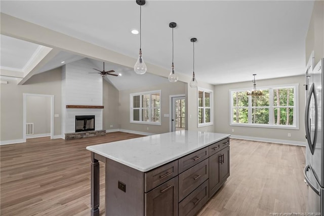 5400 Dowd Rd, West End, NC 27376 - kitchen with freestanding refrigerator, baseboards, ceiling fan, light countertops, and light wood-style flooring