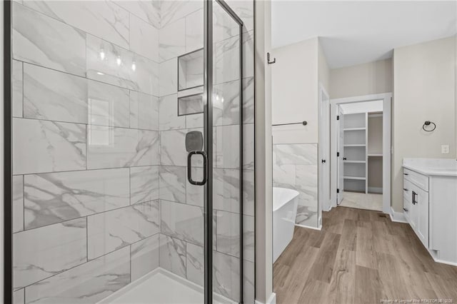 5400 Dowd Rd, West End, NC 27376 - bathroom featuring a freestanding bath, a stall shower, vanity, wood finished floors, and a walk in closet