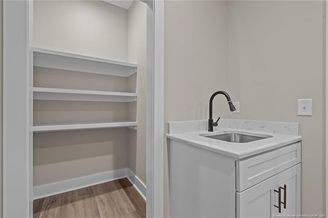 5400 Dowd Rd, West End, NC 27376 - washroom featuring a sink, wood finished floors, and baseboards
