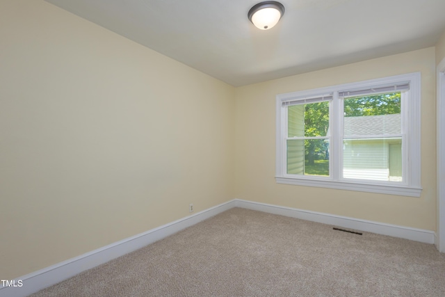 605 E Montgomery St, Henderson, NC 27536 - unfurnished room with light carpet and baseboards