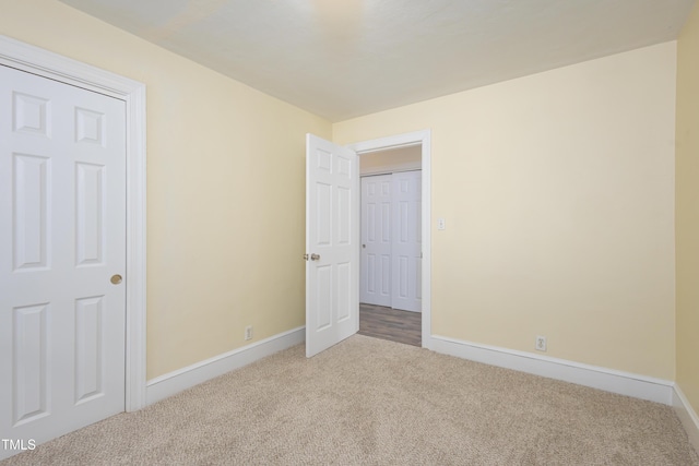 605 E Montgomery St, Henderson, NC 27536 - unfurnished bedroom featuring carpet floors and baseboards