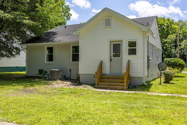 605 E Montgomery St, Henderson, NC 27536 - back of property featuring entry steps, a shingled roof, a lawn, and brick siding