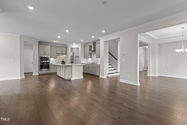 3020 Mavisbank Cir, Apex, NC 27502 - unfurnished living room with a sink, a chandelier, recessed lighting, crown molding, and dark wood-style flooring