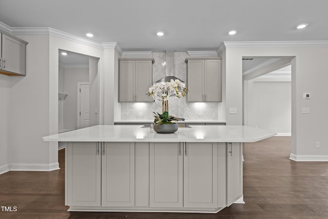 3020 Mavisbank Cir, Apex, NC 27502 - kitchen with gray cabinets, baseboards, wall chimney range hood, light countertops, and a kitchen island with sink