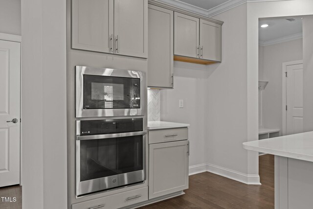 3020 Mavisbank Cir, Apex, NC 27502 - kitchen featuring stainless steel appliances, crown molding, dark wood-style flooring, baseboards, and light countertops