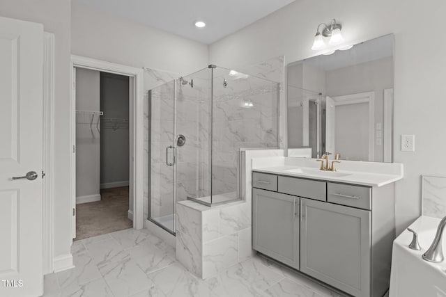 3020 Mavisbank Cir, Apex, NC 27502 - full bath featuring marble look tile flooring, a marble finish shower, vanity, baseboards, and a tub to relax in