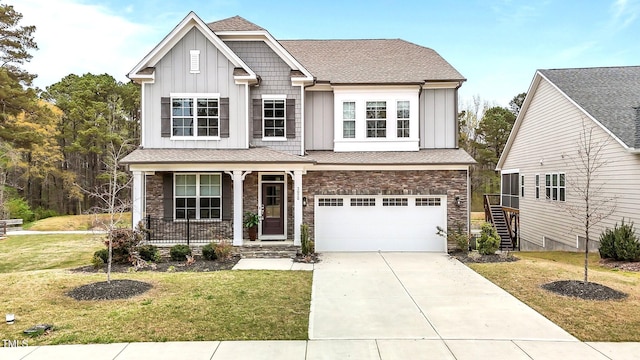 3020 Mavisbank Cir, Apex, NC 27502 - view of front facade with board and batten siding, covered porch, an attached garage, and stone siding