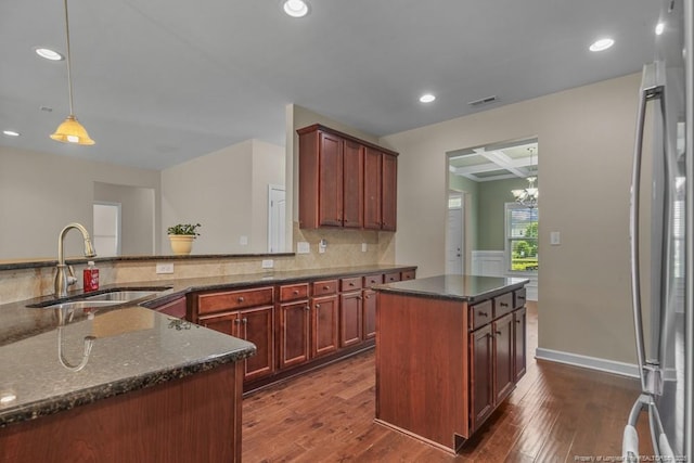 2240 Andalusian Dr, Hope Mills, NC 28348 - kitchen featuring a sink, dark wood finished floors, tasteful backsplash, dark stone countertops, and recessed lighting