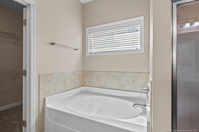 2240 Andalusian Dr, Hope Mills, NC 28348 - bathroom featuring a bath and a spacious closet