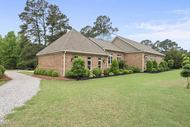 8042 N NC Highway 58, Castalia, NC 27816 - view of side of property featuring brick siding, a lawn, a shingled roof, and driveway
