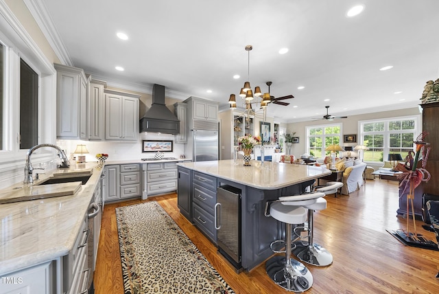 8042 N NC Highway 58, Castalia, NC 27816 - kitchen with gray cabinetry, a sink, appliances with stainless steel finishes, wine cooler, and custom range hood