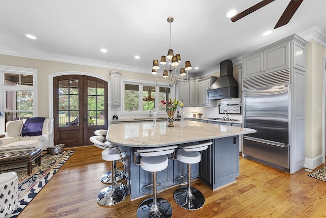 8042 N NC Highway 58, Castalia, NC 27816 - kitchen featuring built in fridge, custom range hood, light stone counters, ceiling fan, and a chandelier