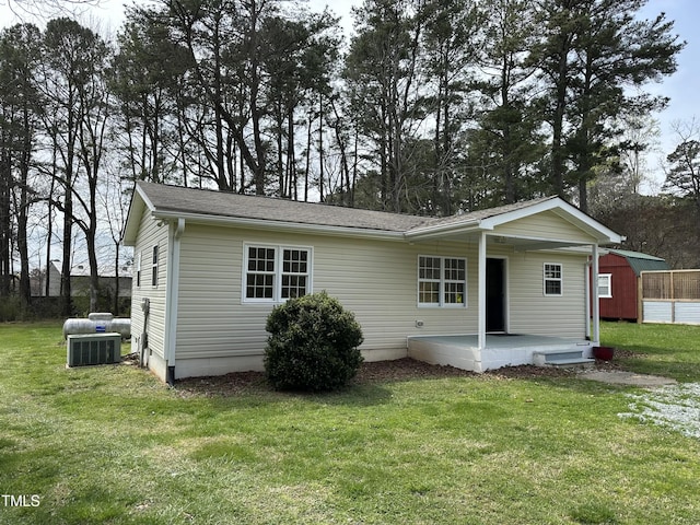 726 Thompson St, Pittsboro, NC 27312 - view of front of home featuring central AC unit, a front lawn, and a shingled roof