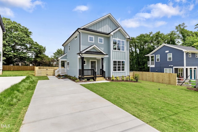2521 Newbold St, Raleigh, NC 27603 - view of front of home with board and batten siding, covered porch, and driveway