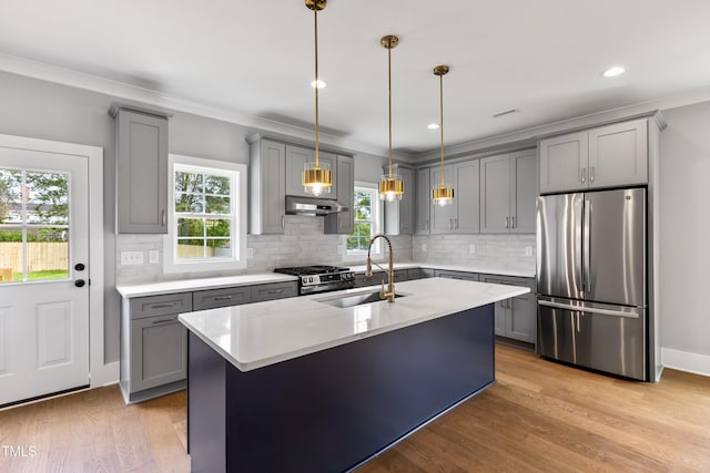 2521 Newbold St, Raleigh, NC 27603 - kitchen with stainless steel appliances, gray cabinetry, a sink, under cabinet range hood, and decorative backsplash