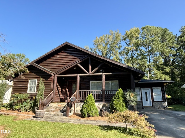 603 Hugo St, Durham, NC 27704 - view of front facade featuring covered porch and faux log siding